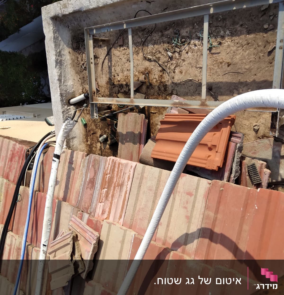 צינורות וכבלים על גג עם רעפים שבורים